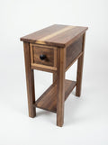 Walnut side table with a drawer and shelf on a white background