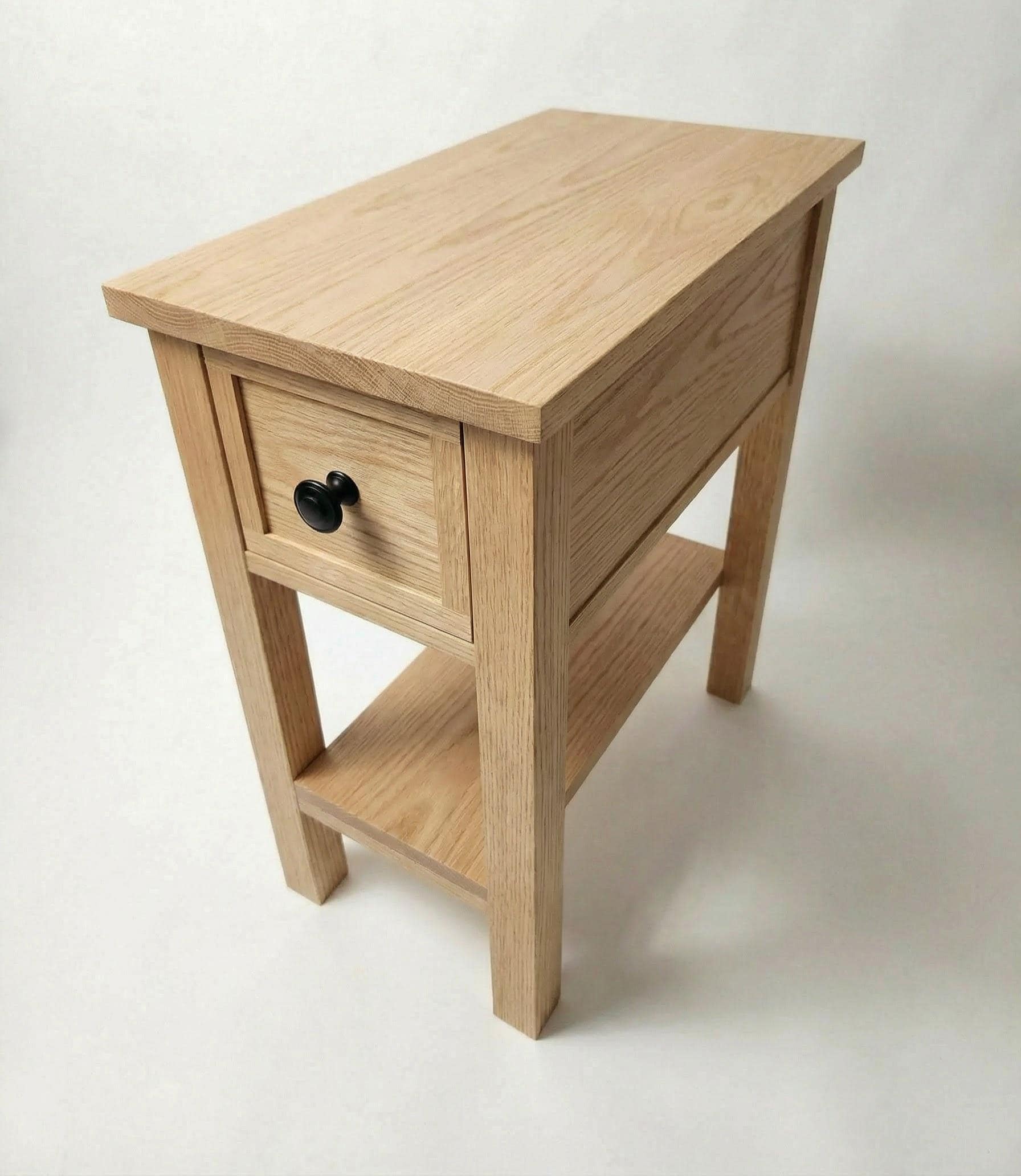 Wooden side table with a drawer on a white background