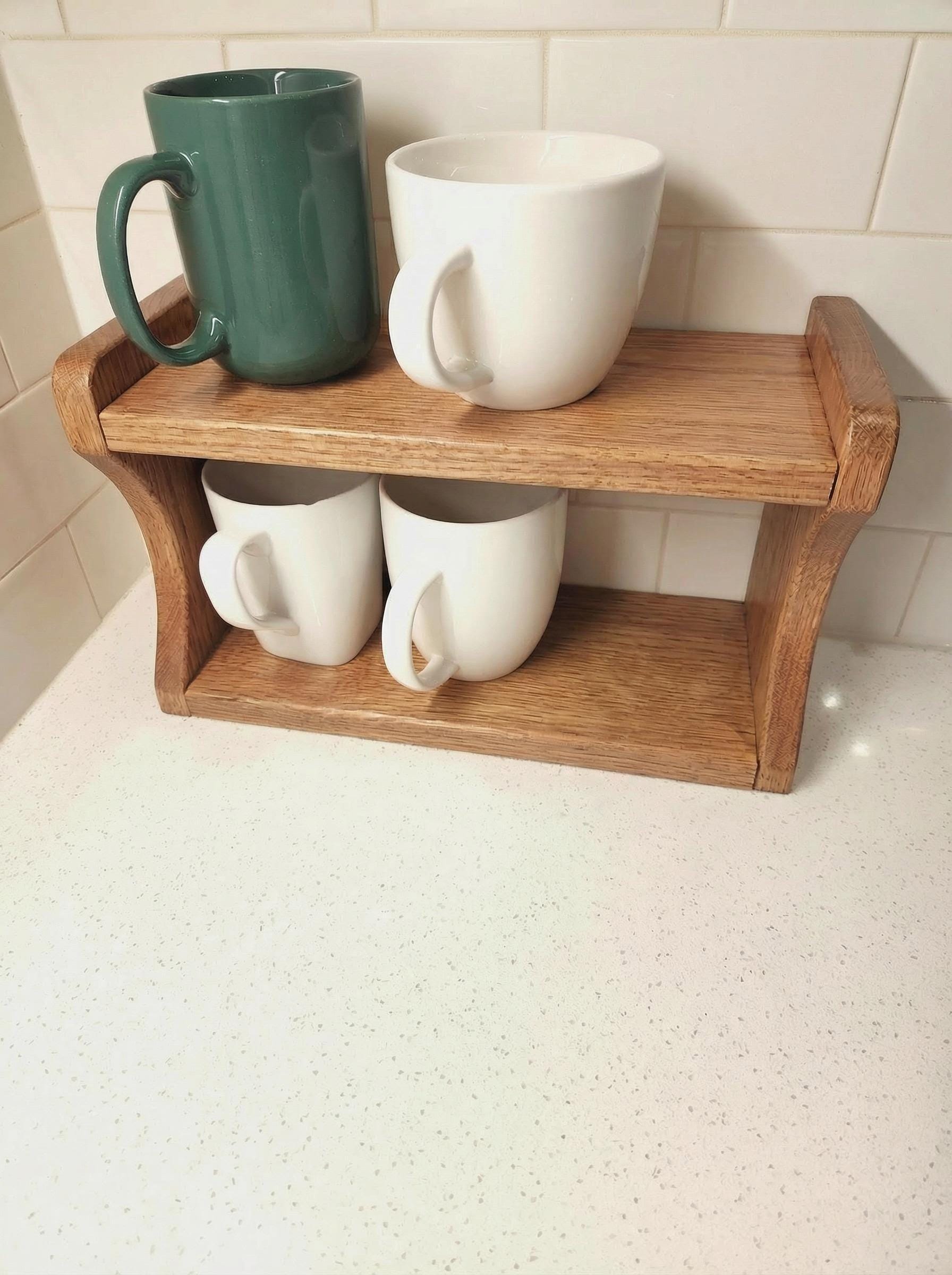 Handmade oak kitchen shelf with mugs and plants, rustic wood organizer