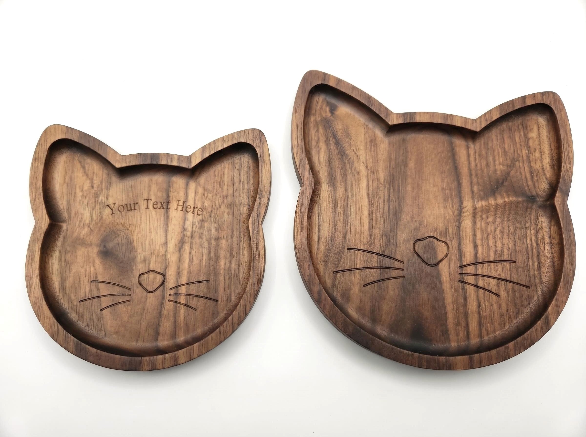 Two wooden cat-shaped trays on a white background