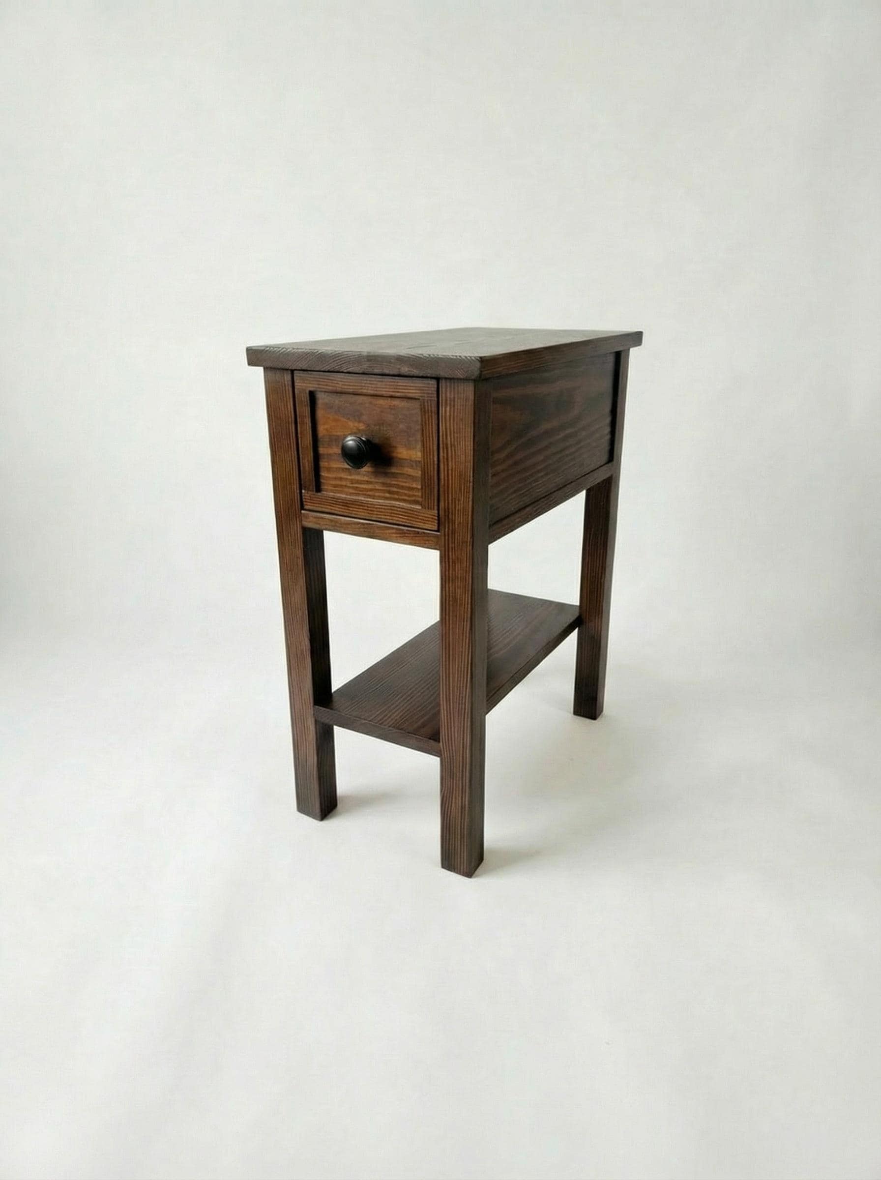 Wooden side table with a drawer on a white background
