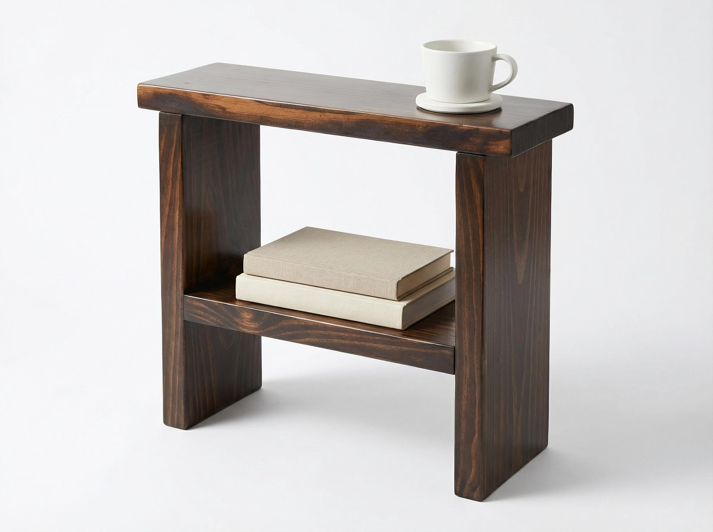 Wooden side table with a book and a cup on a white background