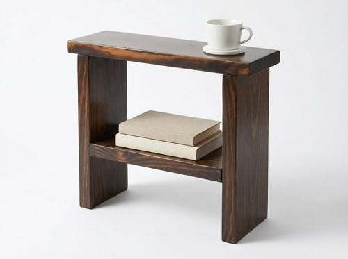 Wooden side table with a book and a cup on a white background